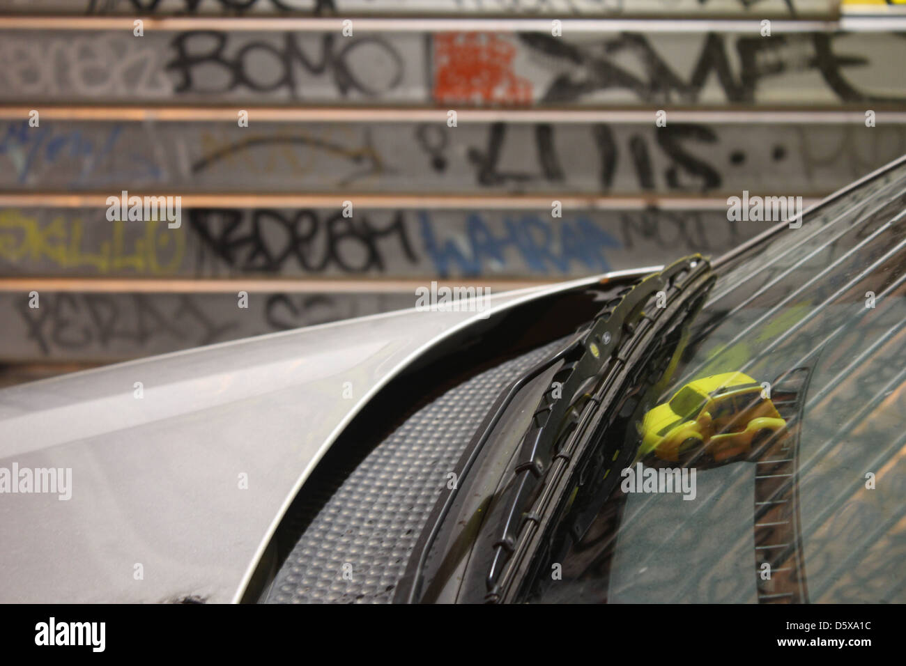 toy car in window with graffiti on shop shutters in rome italy Stock Photo Alamy