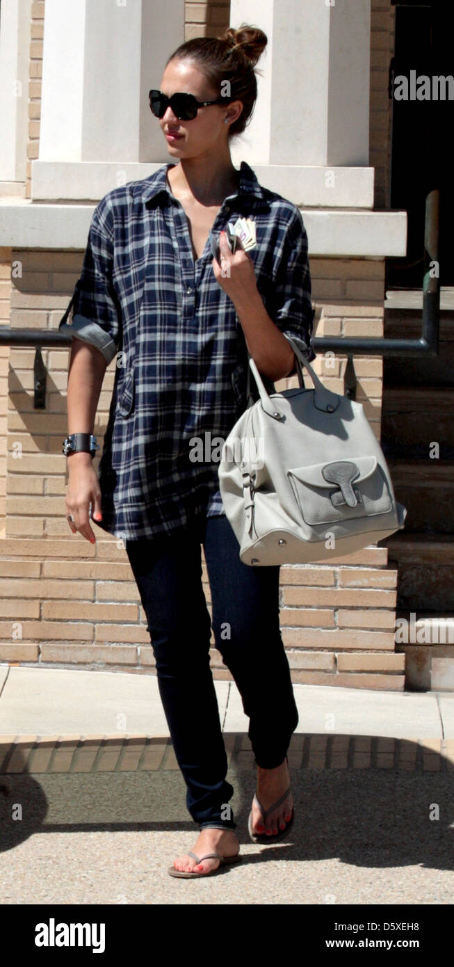 Jessica Alba shows off her baby bump while exiting Barney's Of New York