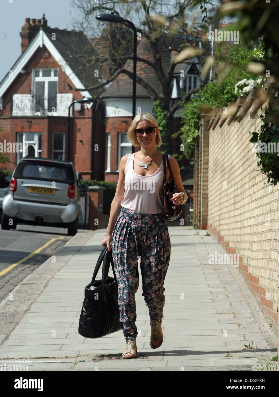 Denise Van Outen is seen leaving her home in a floral spring outfit and