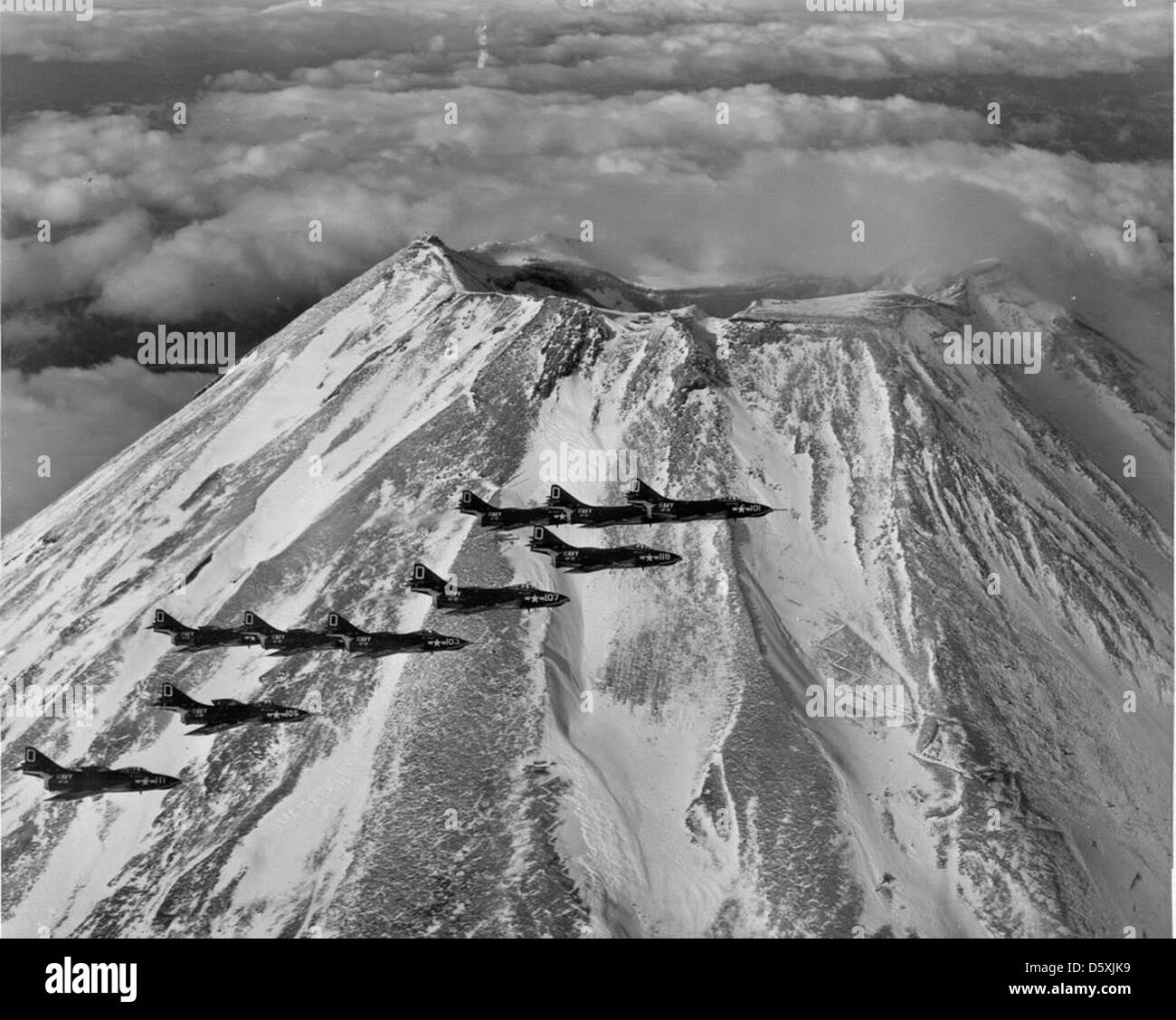 Grumman F9F-8 'Cougar' flight passing by Mt. Fugi, 1956. Stock Photo