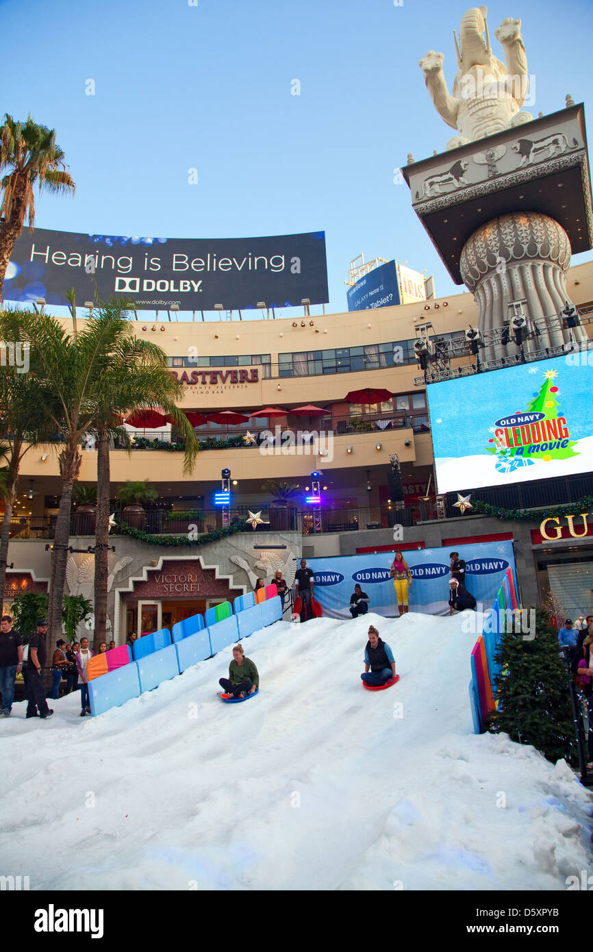 Sledding on imported snow at Hollywood and Highland for Christmas shoppers on 12/8/2012. Hollywood, Los Angeles, California, USA Stock Photo