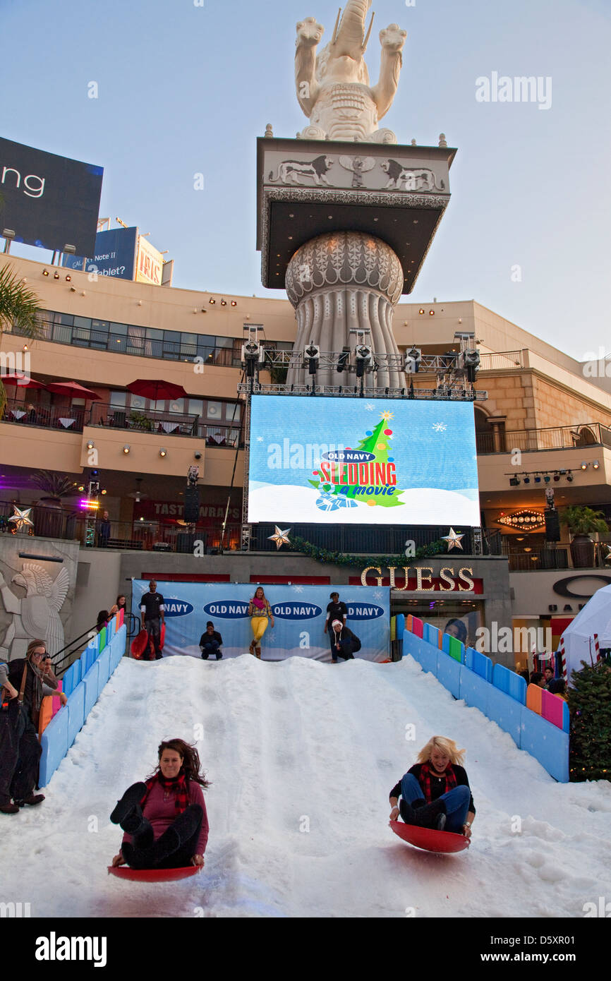 Sledding on imported snow at Hollywood and Highland for Christmas shoppers on 12/8/2012. Hollywood, Los Angeles, California, USA Stock Photo