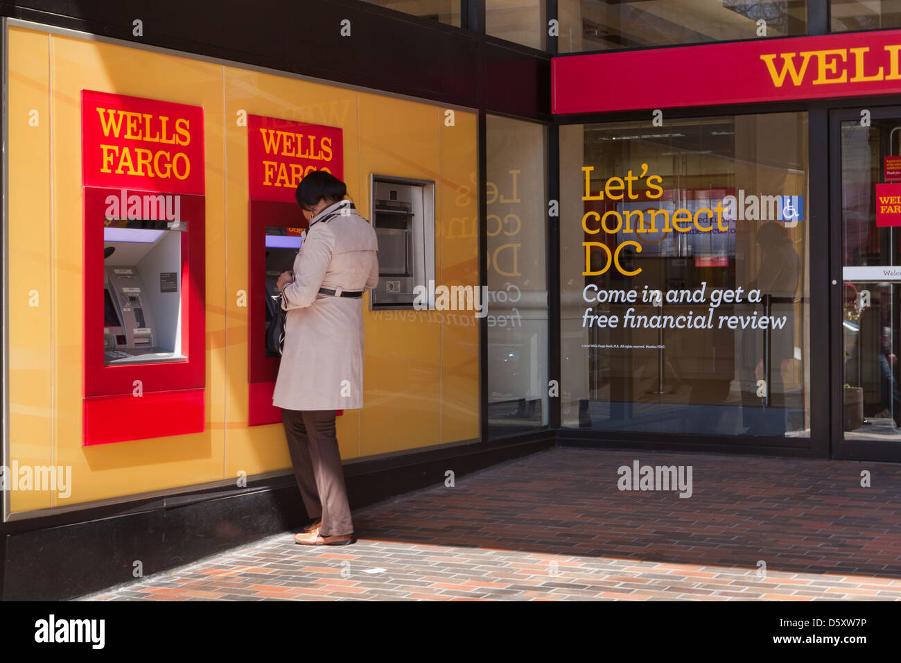 Woman using Wells Fargo ATM - USA Stock Photo