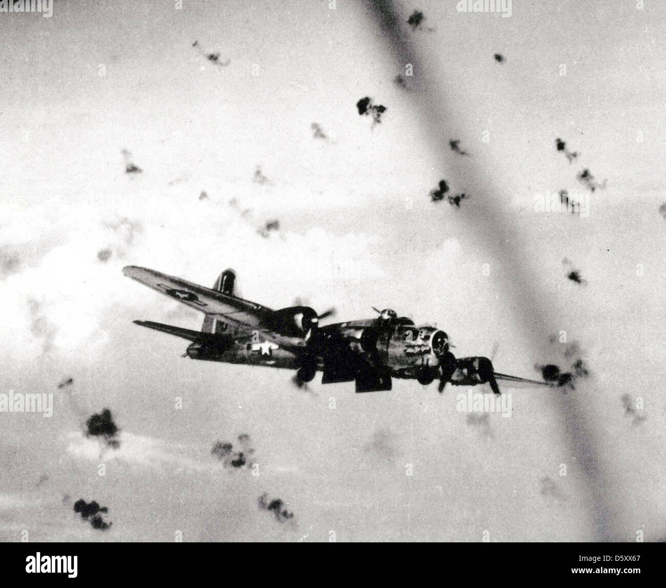 A Boeing B-17 'Flying Fortress' fly's through flak on its way to a bombing target. Stock Photo