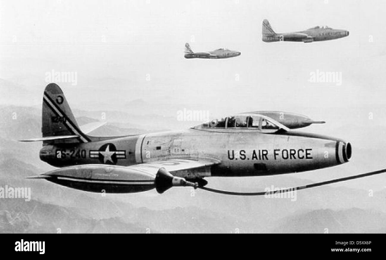 The Republic F-84G-25-RE Thunderjet of the 9th FBG and 49th FBG is refueled in-flight over Korea during the Korean War in 1953. The Thunderjet was a key aircraft for tactical bombing and ground attack missions. Stock Photo