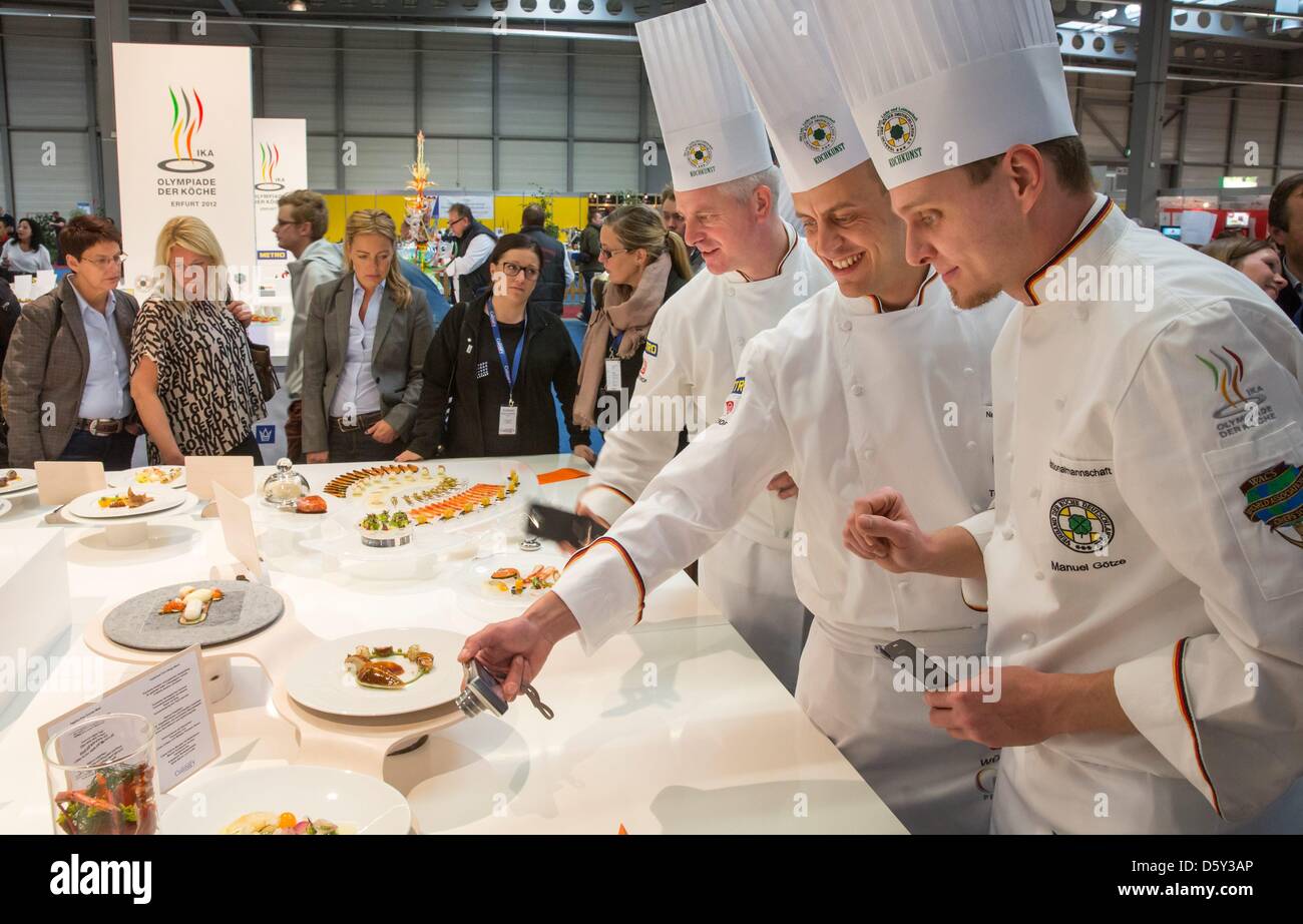 Cooks from the German national team look at the showpieces of the Norwegian cooks at International Exhibition of Culinary Art in Erfurt, Germany, 09 October 2012. The largest culinary exhibition in the world is drawing gourmet chefs to Erfurt. Creations by professional teams from around 50 countries can be tasted daily. Tomorrow the awards ceremony will take place. Photo: MICHAEL R Stock Photo