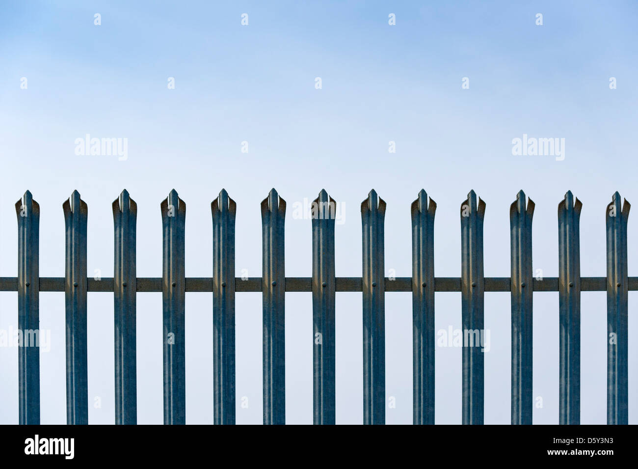 Security Metal Fence Against a blue sky Stock Photo