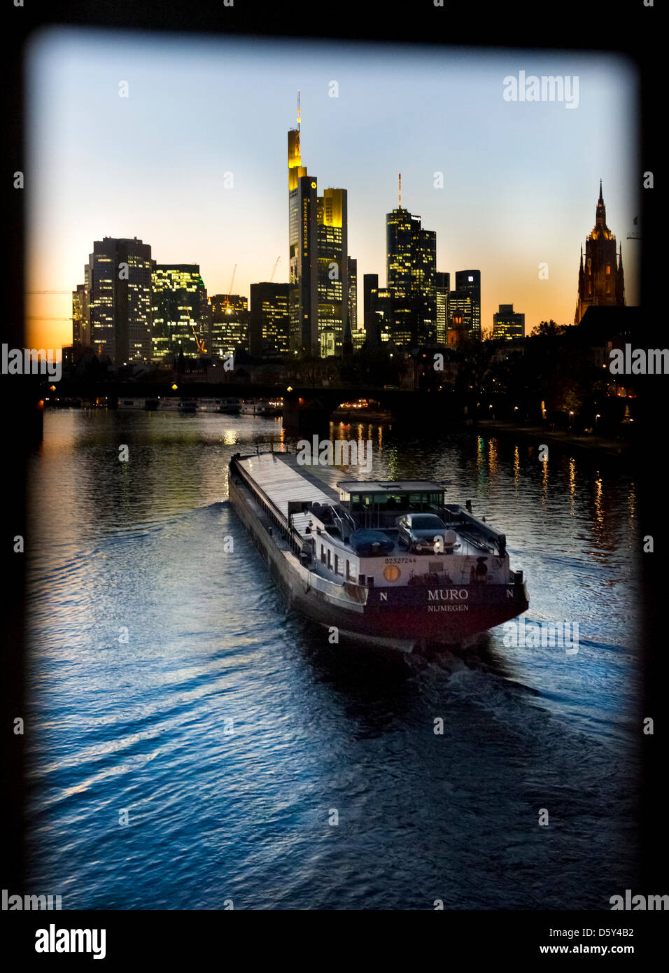 The skyline of Frankfurt is visible behind a ship driving on the river Main, Germany, 10 October 2012. Photo: Nicolas Armer Stock Photo