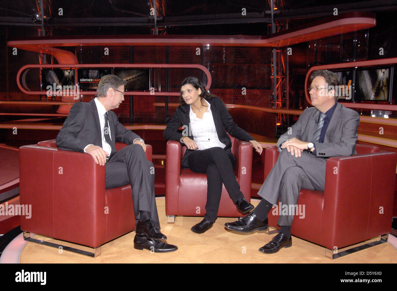 Swiss weather expert Joerg Kachelmann (R) and his wife Miriam appear as guest at Guenther Jauch's (L) ARD talk show in Berlin, Germany, 14 October 2012. Photo: Karlheinz Schindler Stock Photo