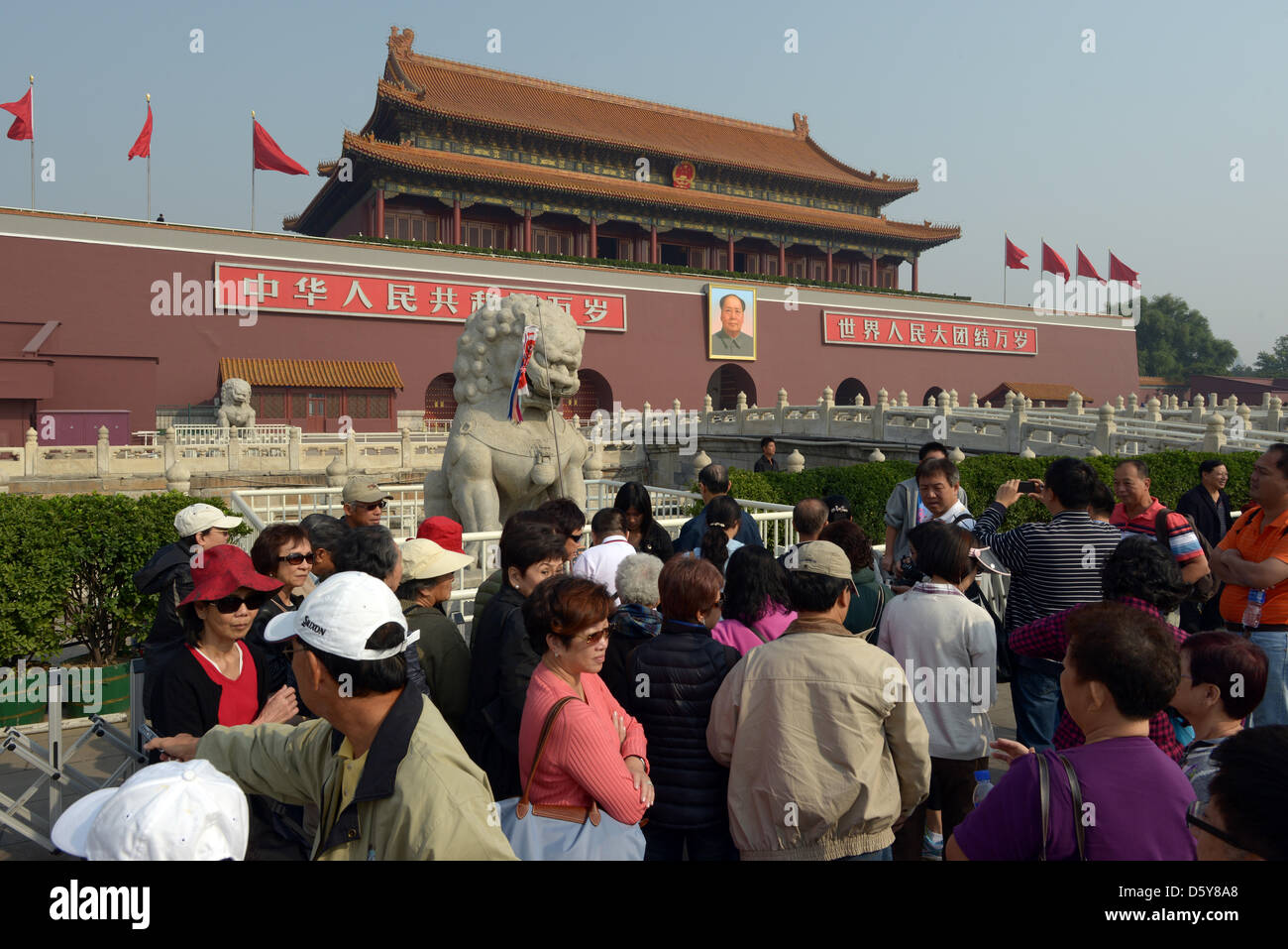 Many tourists stand in front of the main entrance to the Forbidden City, which carries a portrait of Mao Zedong, in Beijing, China, 12 October 2012. Photo: Rainer Jensen Stock Photo
