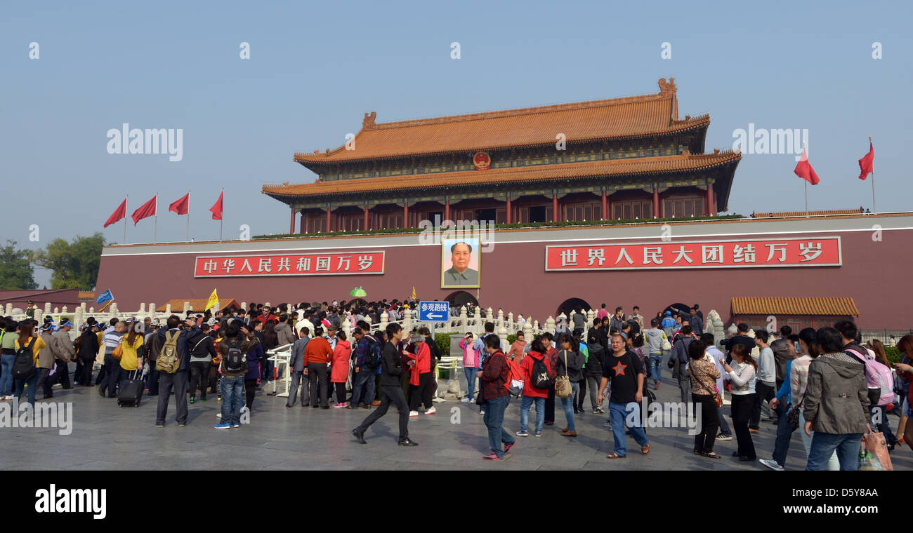 Many tourists stand in front of the main entrance to the Forbidden City, which carries a portrait of Mao Zedong, in Beijing, China, 12 October 2012. Photo: Rainer Jensen Stock Photo