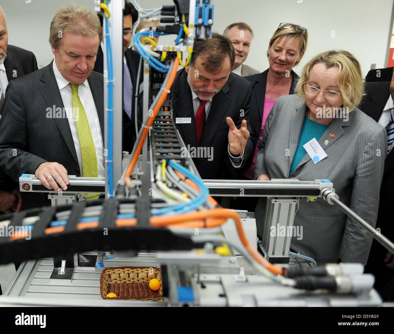 Baden-Wuerttemberg's Environment Minister Franz Untersteller (L), Baden-Wuerttemberg's Minister of Economy Theresia Bauer (R), chairwoman of The Greens in Baden-Wuerttemberg, Edith Sitzmann (2-R) and manager of the Festo Plant, Otto Bauer, observe a Festo machine at a factory of Festo in Instanbul, Turkey, 18 October 2012. The state government of Baden-Wuerttemberg is on a visit to Stock Photo