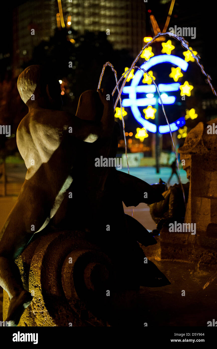 The Euro sculpture is seen behind a fountain statue at Willy-Brandt ...