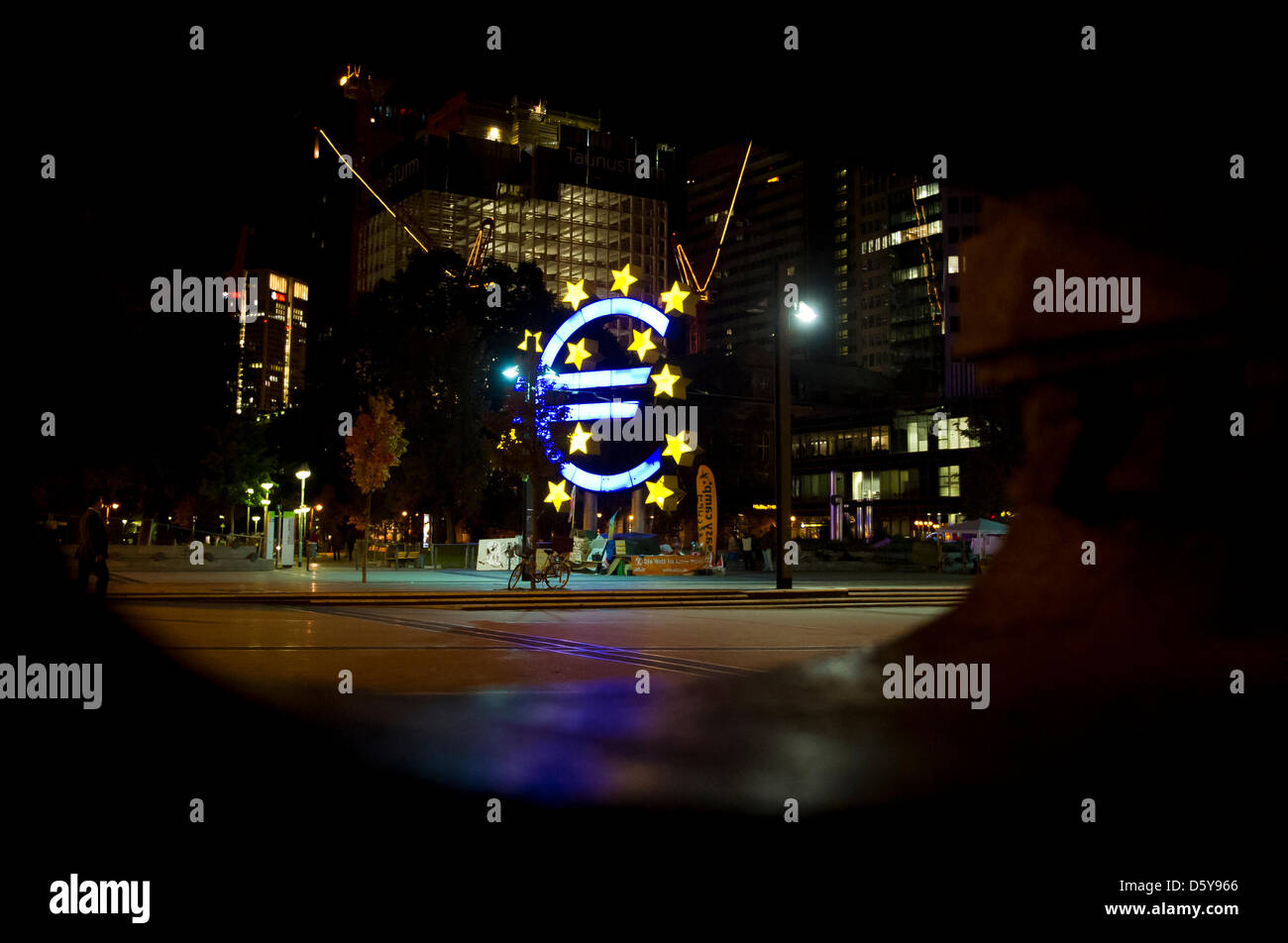 The Euro sculpture is seen behind a fountain statue at Willy-Brandt ...