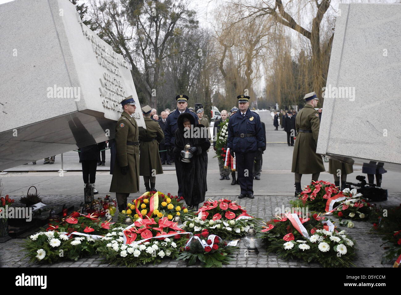 Warsaw, Poland. 10th April 2013. 3rd anniversary of Polish presidental plane crash in Smolensk, Russia in 2010. Government and Parliament members and families lays flowers under the Victims of The Presidental Plane Catastrophe monument in Warsaw at Powazki cemetery. Hanna Gronkiewicz - Waltz Mayor of Warsaw takes part in the ceremony Credit: Michal Fludra / Alamy Live NewsCredit: Michal Fludra /Alamy Live News Stock Photo