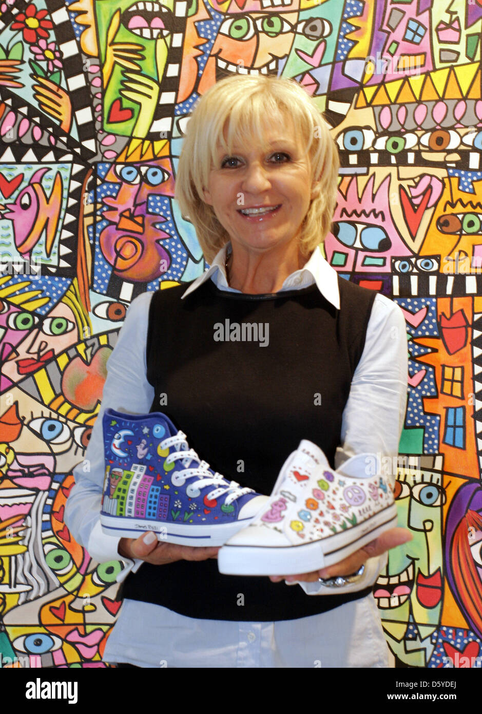Gallery owner Ludmilla Richter presents a shoe collection that was designed  by US American James Rizzi for sports equipment manufacturer Fila at her  art gallery Richter in Berlin, Germany, 29 March 2012.