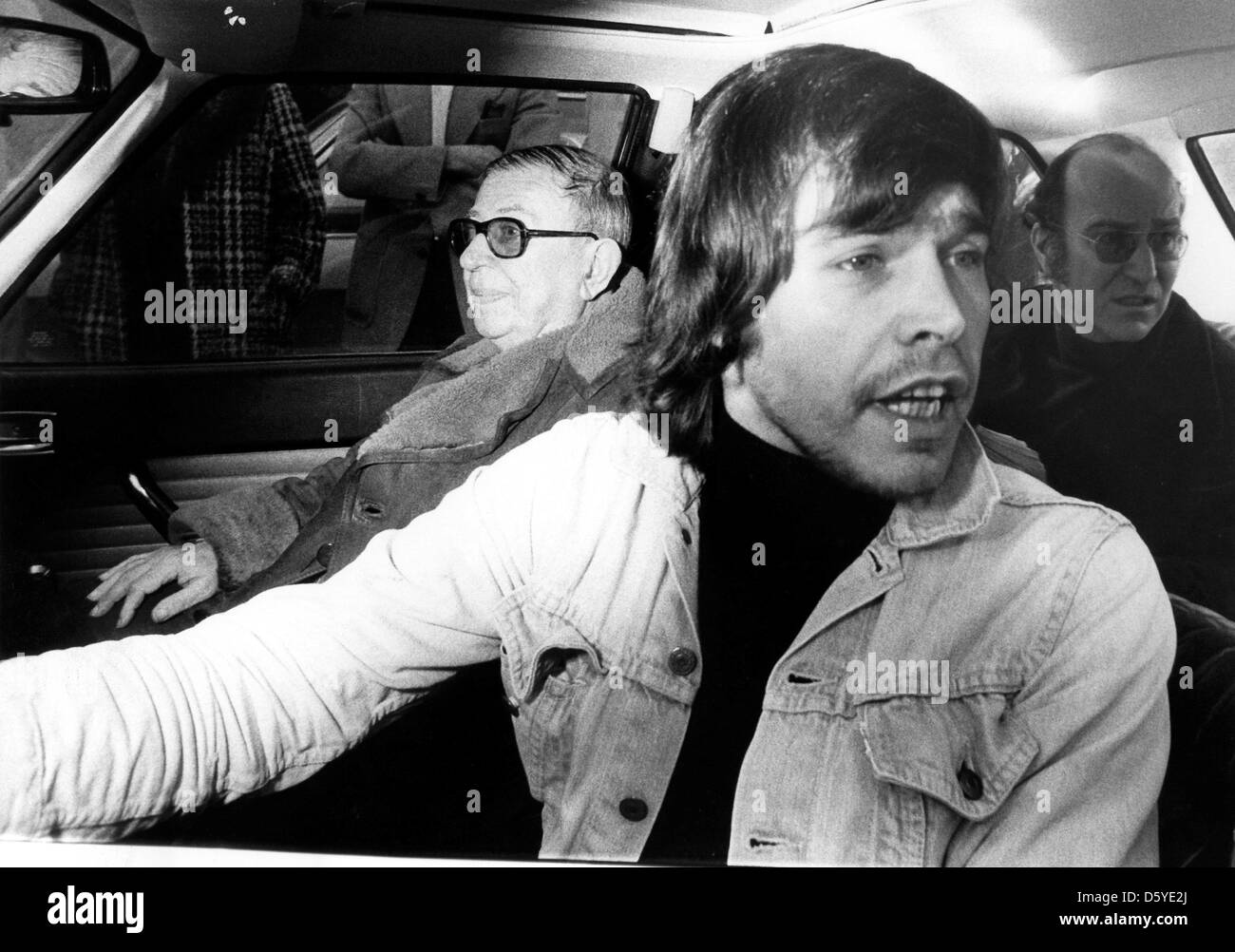 (FILE) An archive photo dated 12 April 1974 shows Hans-Joachim Klein (front), French philosopher Jean-Paul Sartre (L) and lawyer Klaus Croissant during a drive on the way from Stuttgart Airport to Stammheim Prison in Stuttgart, Germany. Sartre spoke with RAF terrorist Baader for one hour at Stammheim Prison in December 1974. Photo: dpa/lsw Stock Photo