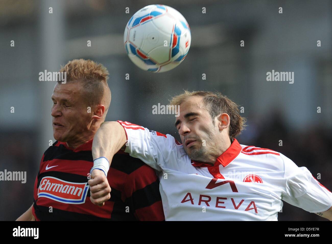Freiburg's Jonathan Schmid (L) vies for the ball with Nuremberg's Javier Pinola during the German Bundesliga match between SC Freiburg and FC Nuremberg at Mage Solar Stadium in Freiburg, Germany, 07 April 2012. Photo: Patrick Seeger (ATTENTION: EMBARGO CONDITIONS! The DFL permits the further utilisation of the pictures in IPTV, mobile services and other new technologies only no ear Stock Photo