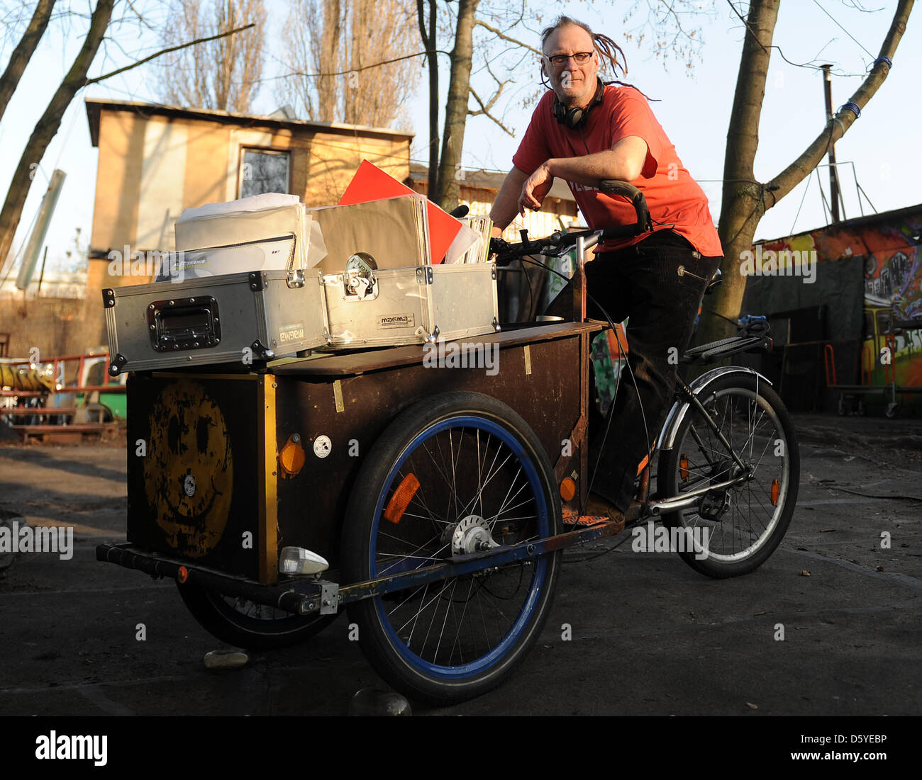 DJ Por No sits on a self-made cargo bike in Berlin, Germany, 16 March 2012. Berlin's techno heroes are growing older, some of the DJs of the first hour will reach retirement age soon. 47 year old DJ Por No, who is called Martin, came to Berlin from Australia at the end of the 90s. DJing alone does not earn a living for him, so he also works in a hostel. Photo: Britta Pedersen Stock Photo
