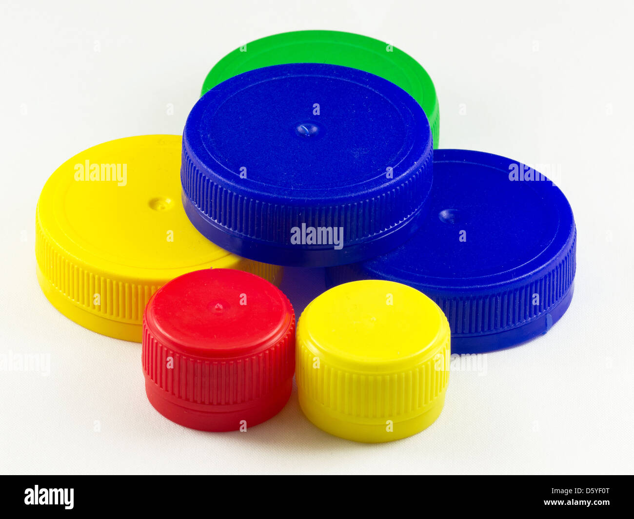 Bunch of multicolored used plastic bottle caps on white background Stock Photo Alamy
