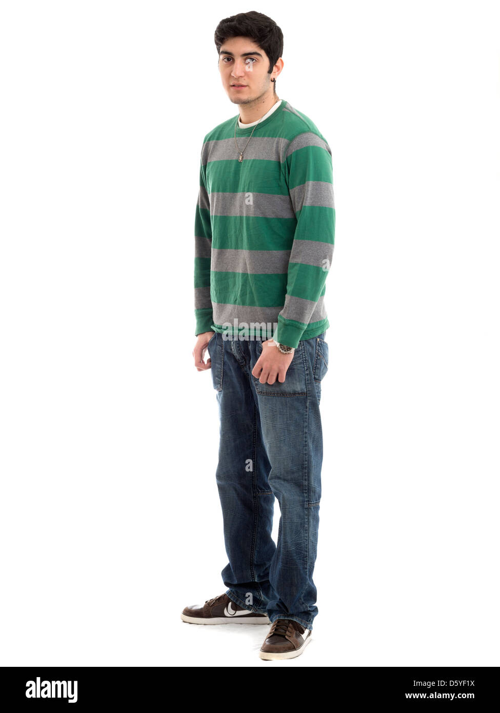 Full length portrait of young man with hands in pockets isolated on white background Stock Photo