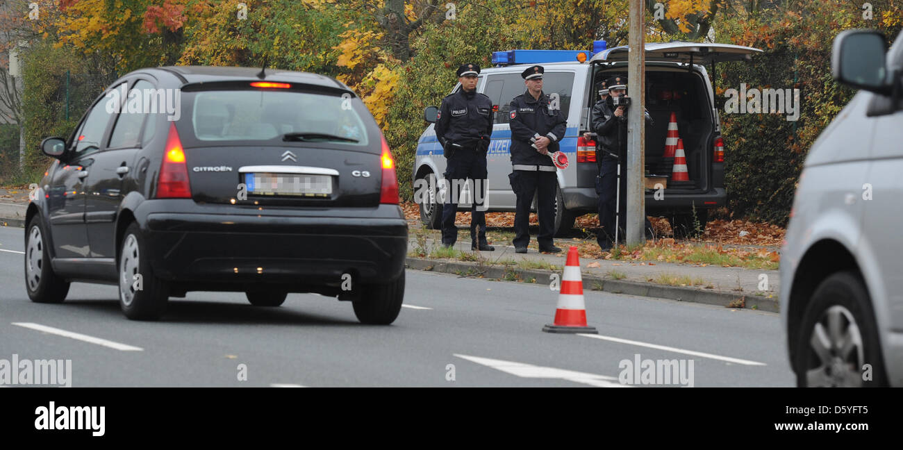 Police officers use a laser speed measuring device in Hanover, Germany, 24  October 2012. Police will carry out speed controls in Lower Saxony, North  Rhine-Westphalia as well as the Netherlands for 24