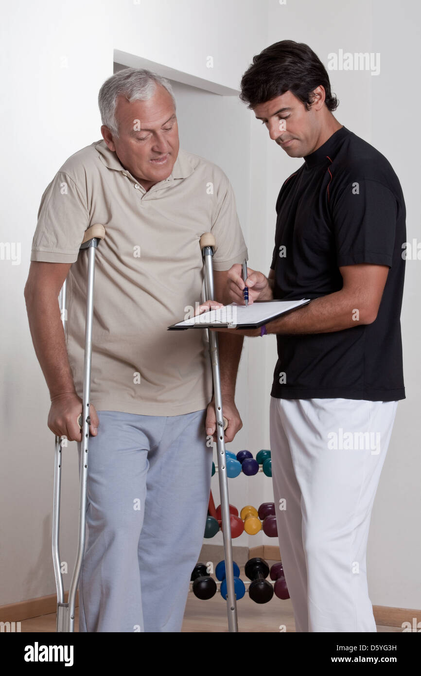 Patient on Crutches and Physician Stock Photo Alamy