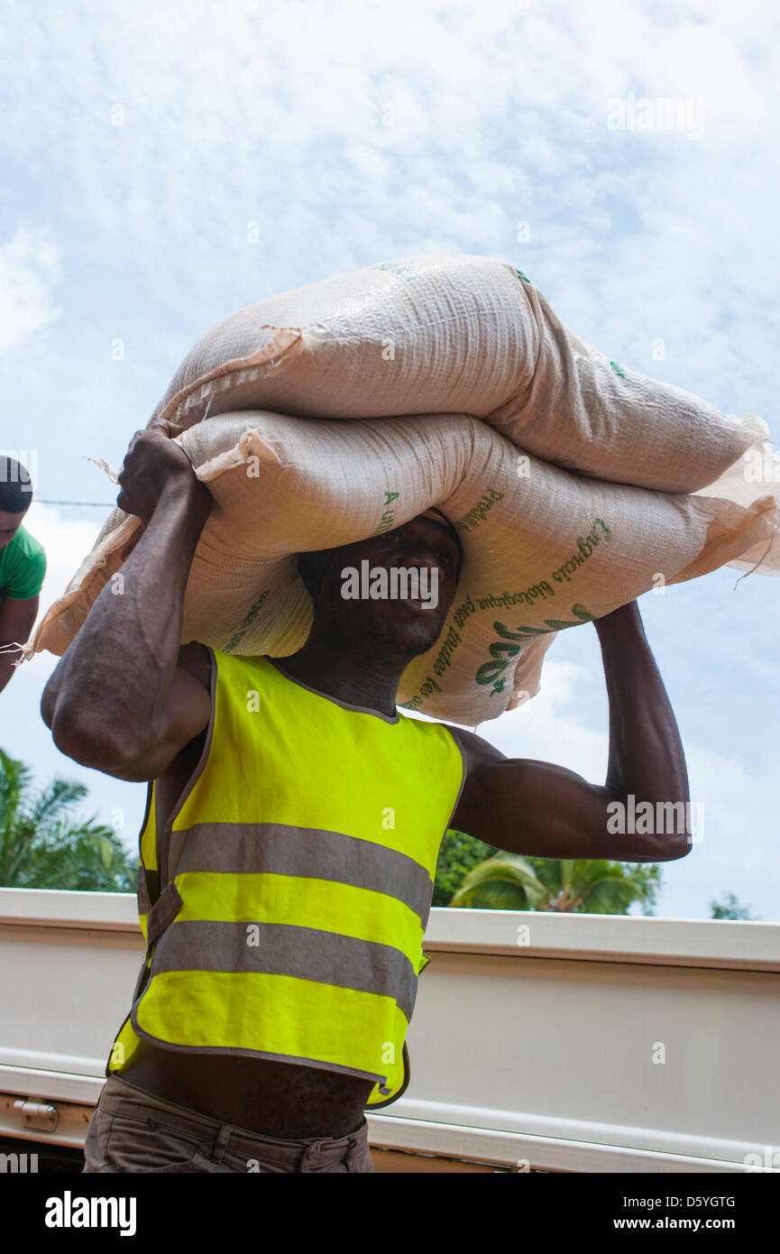 African man carrying bag of fertilizer on his head in Kribi Cameroon