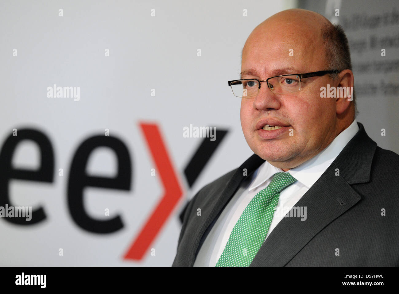 German Environment Minister Peter Altmaier talks in front of the European Energy Exchange (EEX) logo in Leipzig, Germany, 26 October 2012. Altmaier is calling on countries to put aside the north-south conflict for the energy turnaround. Photo: Hendrik Schmidt Stock Photo