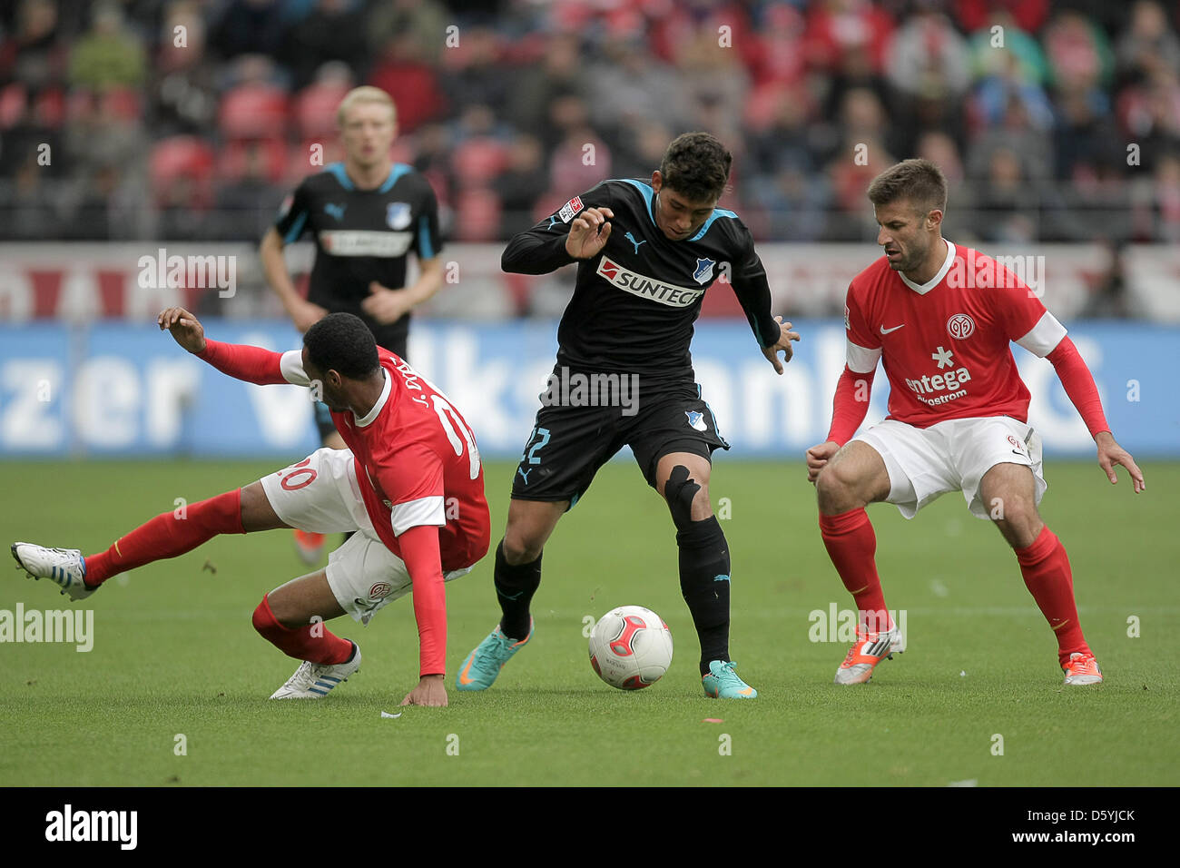 Mainz' Junior Diaz (l) and Marco Caligiuri (r) and Hoffenheim's Roberto Firmino (M) play during a German Bundesliga match between 1 FSV Mainz 05 and 1899 Hoffenheim at the Coface Arena in Mainz, Germany, 27 October 2012. Photo: FREDRIK VON ERICHSEN    (ATTENTION: EMBARGO CONDITIONS! The DFL permits the further utilisation of up to 15 pictures only (no sequntial pictures or video-si Stock Photo