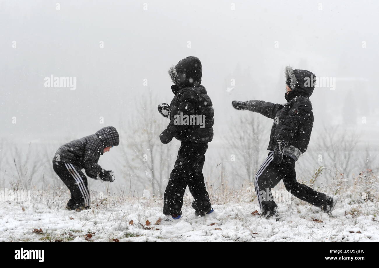 Drei junge Urlauber aus Belgien werfen bei Schneefall am 27.10.2012 in der Nähe des Spitzingsees (Bayern) mit Schneebällen. Foto: Tobias Hase/dp Stock Photo