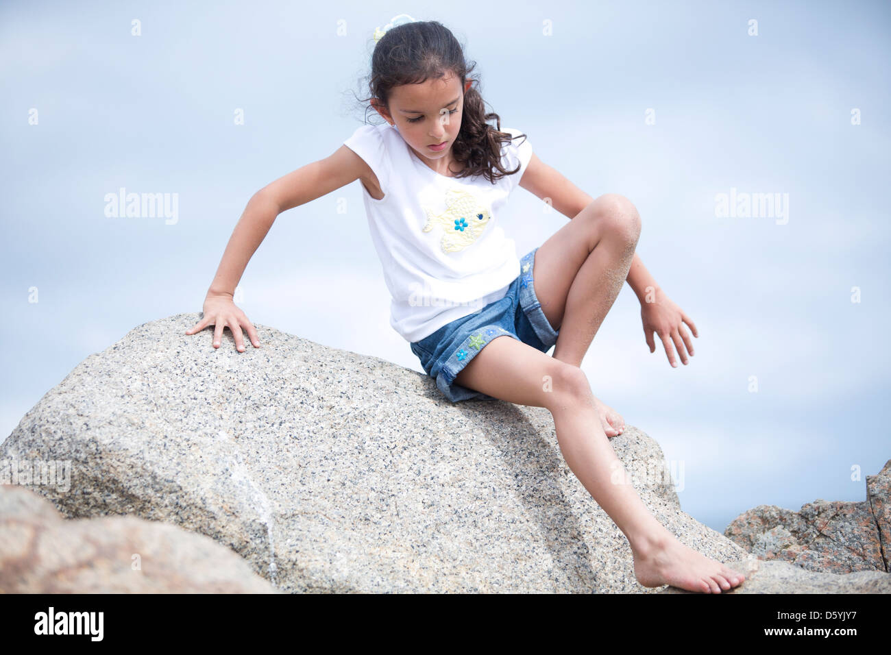 Child climbing down rock hires stock photography and images Alamy