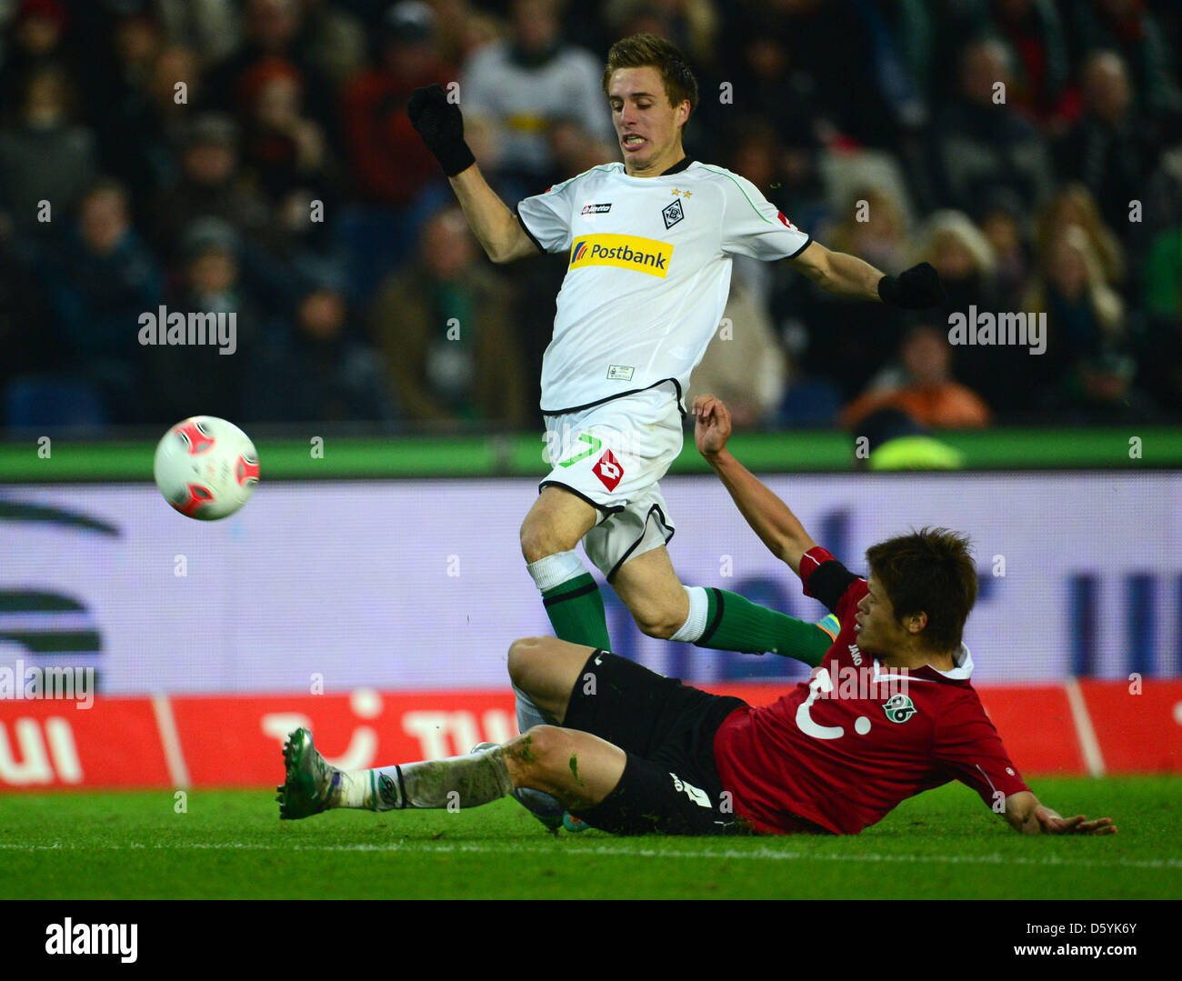 Hanover's Hiroki Sakai (bottom) vies for the ball with Moenchengladbach's Patrick Herrmann during the German Bundesliga soccer match between Hanover 96 and Borussia Moenchengladbach at AWD-Arena in Hanover, Germany, 28 October 2012. Photo: PETER STEFFEN (ATTENTION: EMBARGO CONDITIONS! The DFL permits the further utilisation of up to 15 pictures only (no sequntial pictures or video- Stock Photo