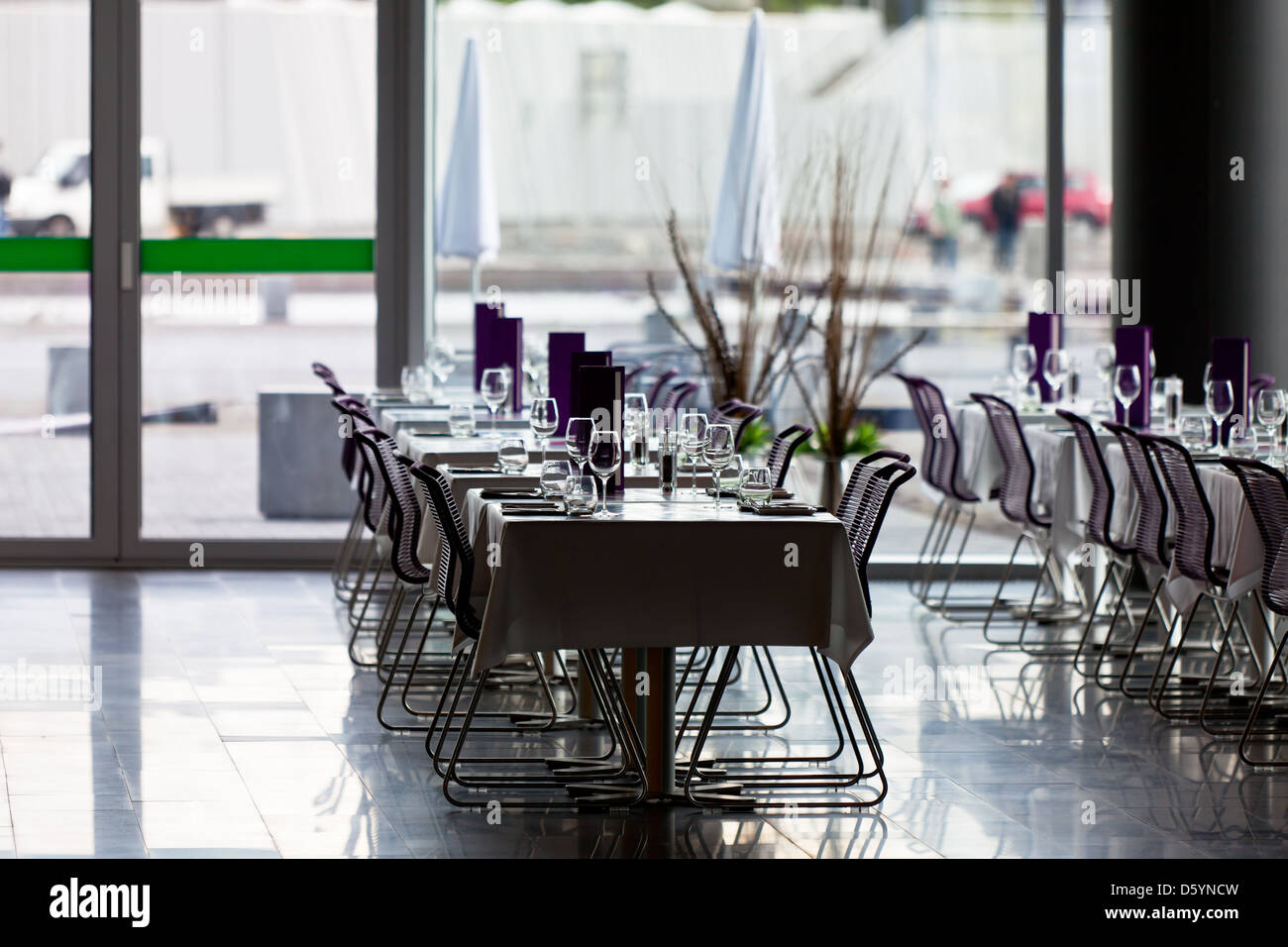 Indoor restaurant tables ready for service. Small GRIP contrejour (against the light) shot Stock Photo