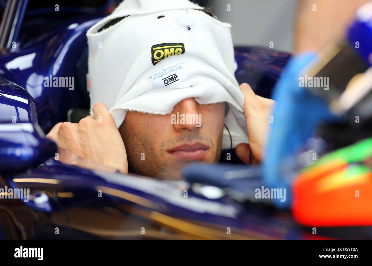 Australian Formula One driver Daniel Ricciardo of Toro Rosso sits in ...