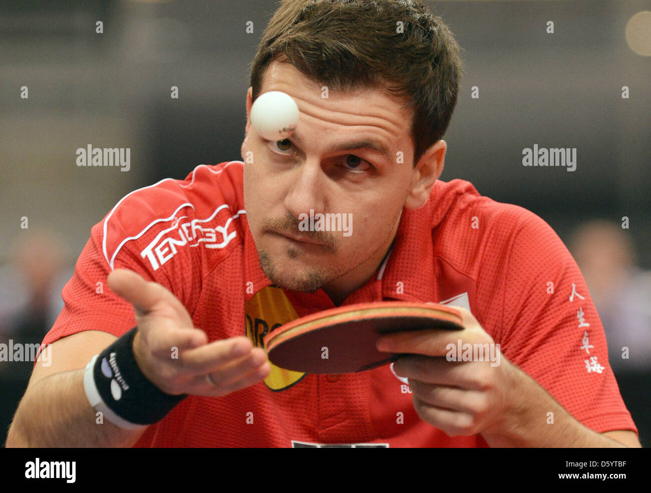 German table tennis player Timo Boll serves the ball during a match