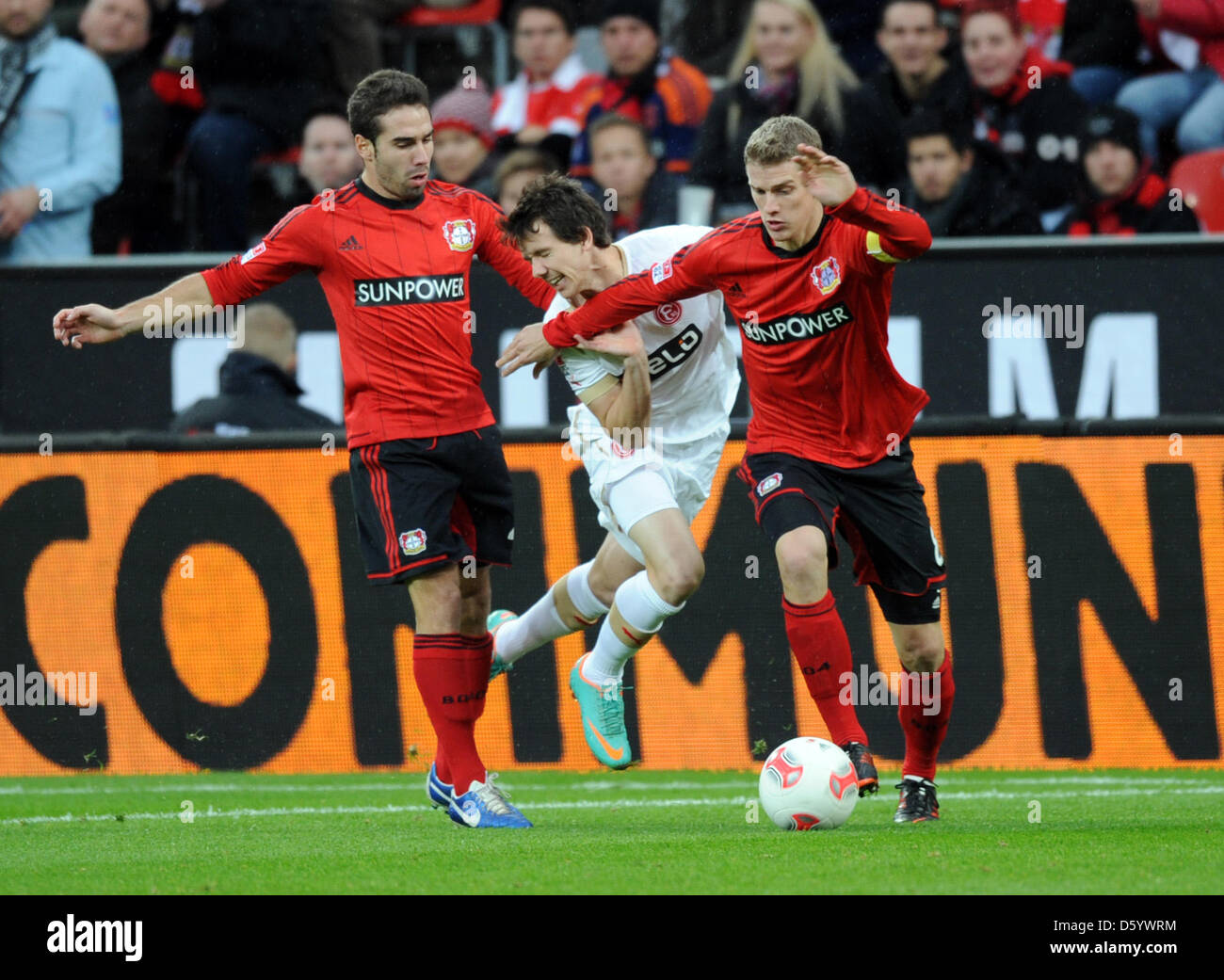 Leverkusen's Dani Carvajal (L) and Lars Bender (R) vies for the ball with Duesseldorf's Robbie Kruse during the German Bundesliga match between Bayer Leverkusen and Fortuna Duesseldorf at BayArena in Leverkusen, Germany, 04 November 2012. Photo: Daniel Naupold  (ATTENTION: EMBARGO CONDITIONS! The DFL permits the further  utilisation of up to 15 pictures only (no sequntial pictures  Stock Photo