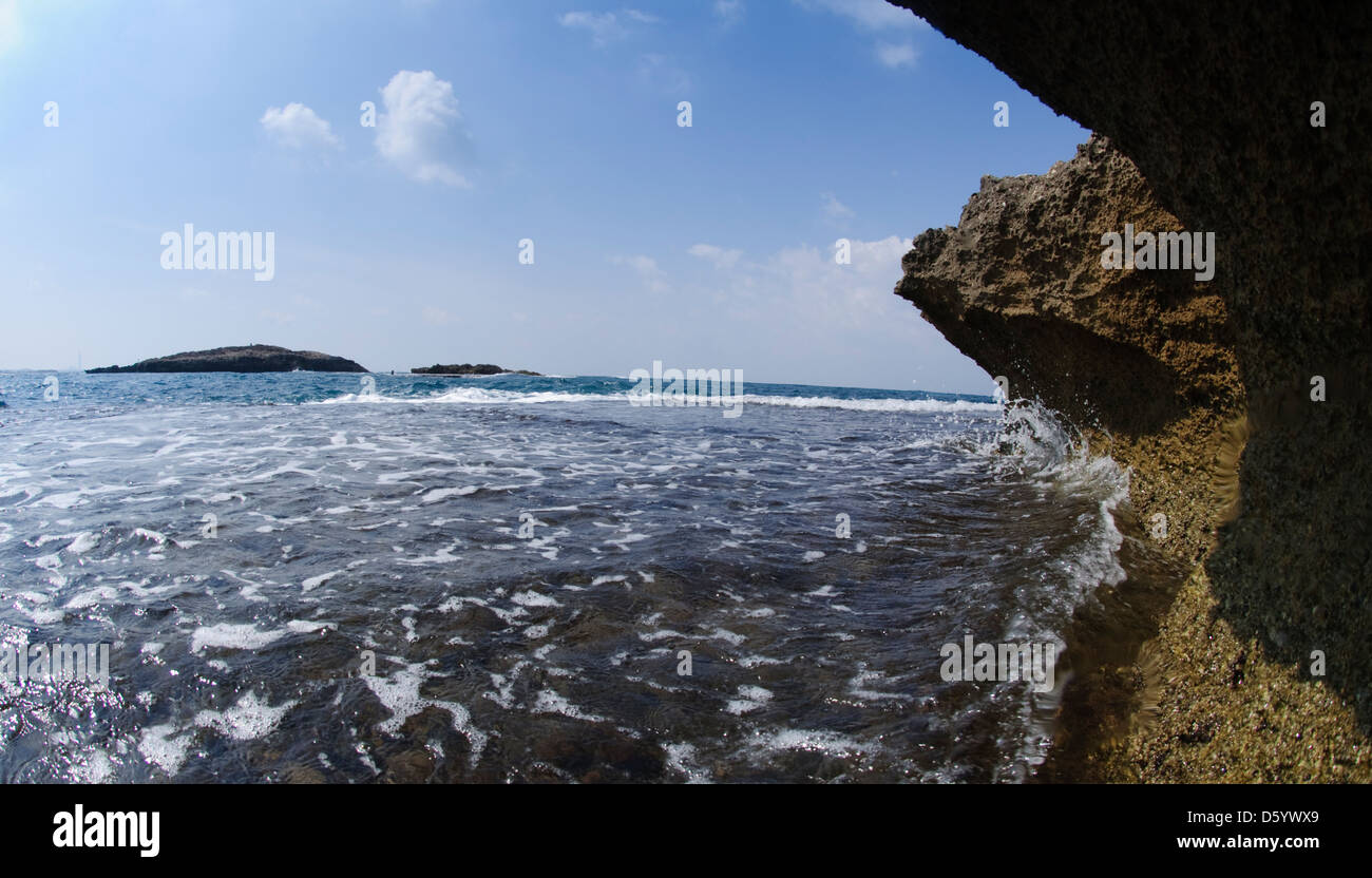 Water abstracts - close up of waves breaking over rocks on a shore Stock Photo