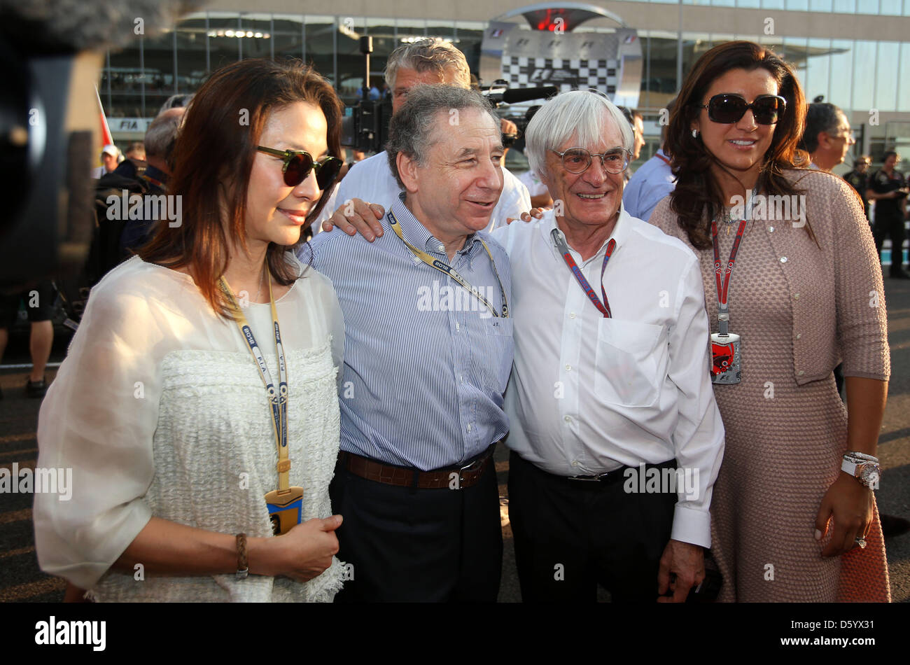 British Formula One Boss Bernie Ecclestone (2.R), his girlfriend Fabiana Flosi (R), French FIA-President Jean Todt (2.L.) and his girlfriend, actress Michelle Yeoh (L) seen before the start of the Formula One Grand Prix of Abu Dhabi at the Yas Marina Circuit in Abu Dhabi, United Arab Emirates, 04 November 2012. Photo: Jens Buettner/dpa Stock Photo