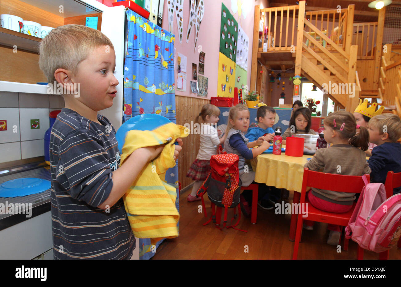  A boy helps doing the dishes at the Kindergarten 'Heilige Familie' in Bildidee 