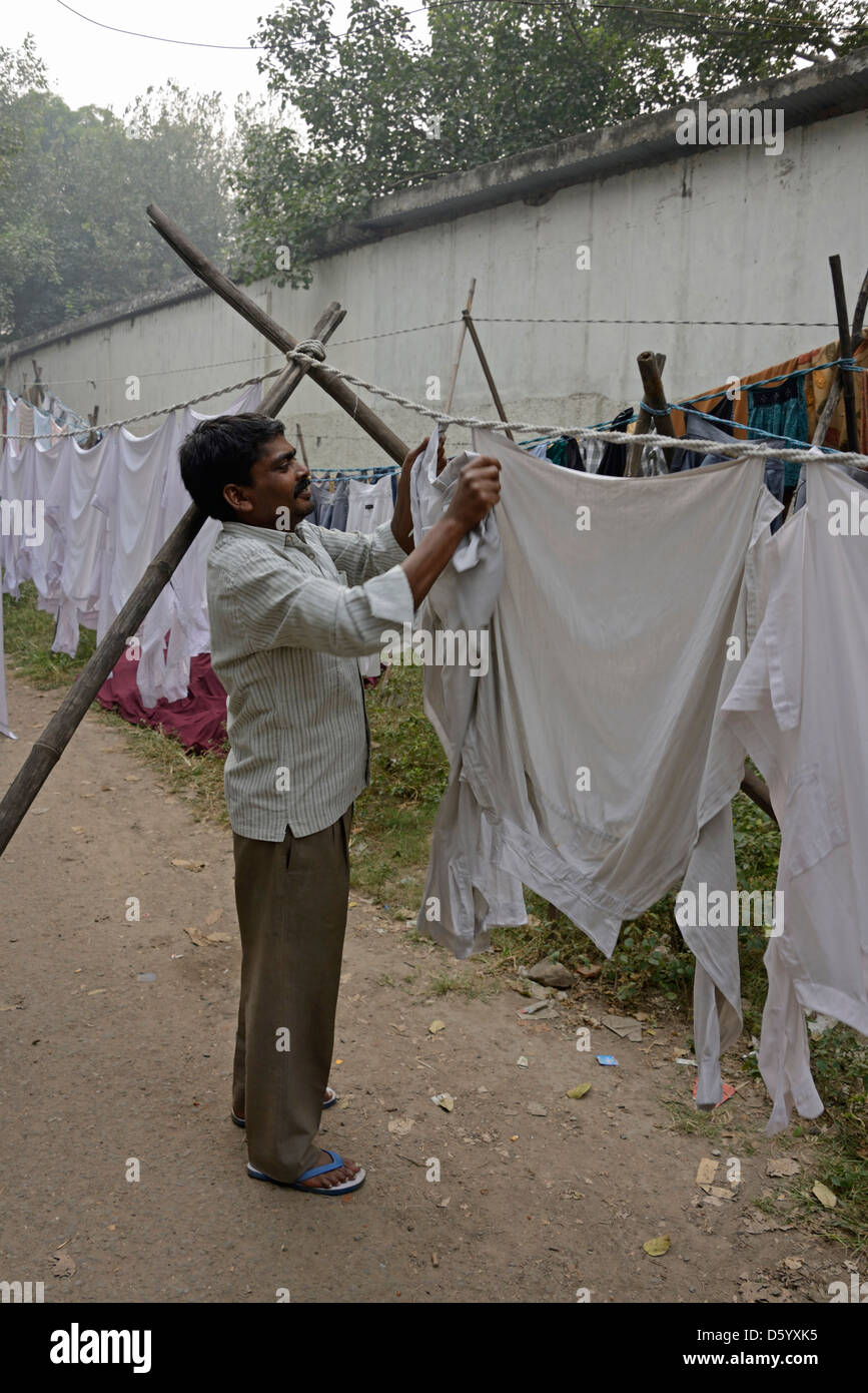 A laundry worker hanging up laundry at a laundry in New Delhi, India