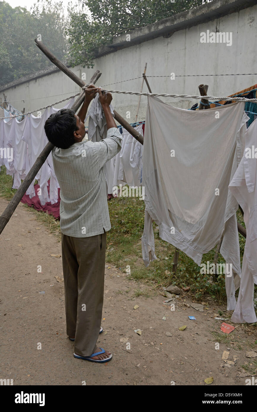 A laundry worker hanging up laundry at a laundry in New Delhi, India