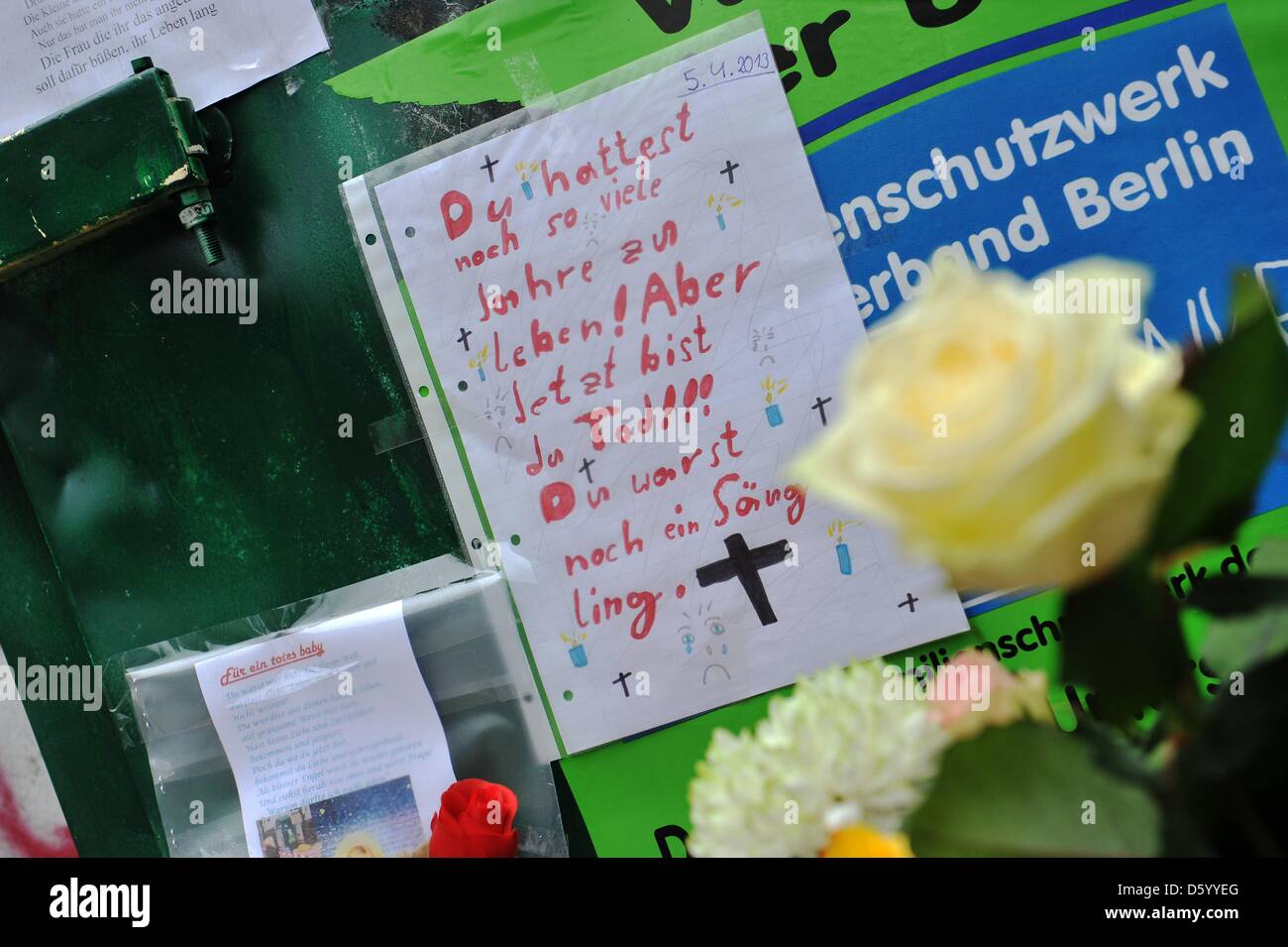 Flowers, candles, soft toys and greetin cards have been placed in front of  a container for second hand clothes, where a dead baby was found on 05  April 2013, in Berlin-Neukoelln, Germany,