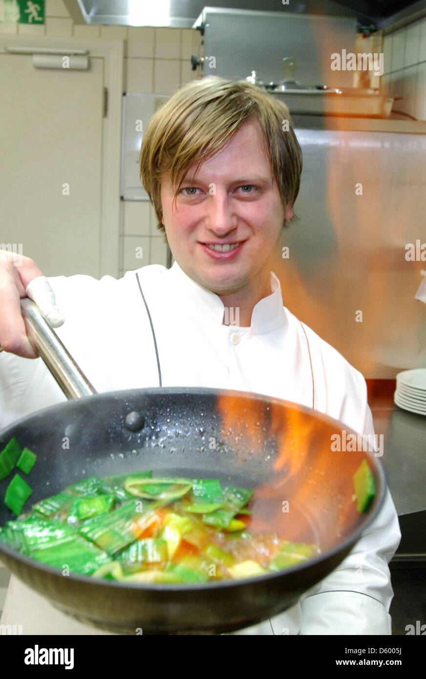 FILE - An archive picture dated 14 November 2007 shows chef Kevin Fehling flambeeing vegetables in the kitchen of his gourmet restaurant 'La Belle Epoque' of Hotel Columbia in Travemuende, Germany, 14 November 2012. Restaurant guide 'Michelin' has awarded Fehling its third star on 07 November 2012. Fehling's restaurant is only the tenth to be awarded three stars in Germany. Photo:  Stock Photo