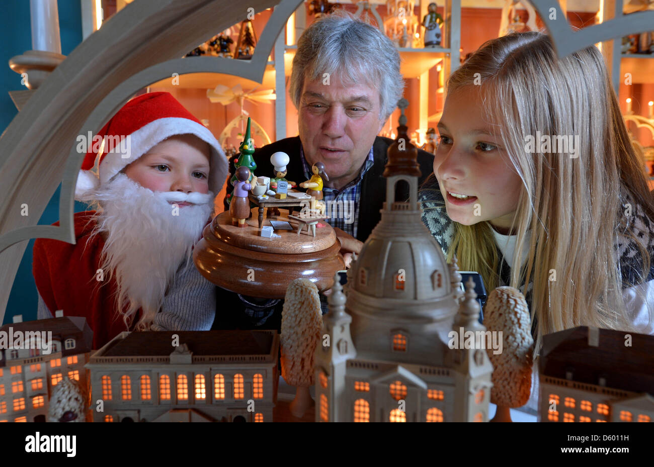 Songwriter Rolf Zuckowski with nine-year old pupils Pia (L) and Sophie look at a new music box
