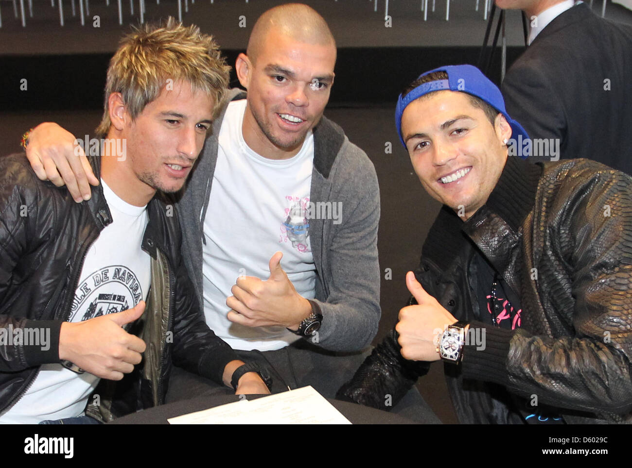 A handout picture taken on 8 November 2012 shows the Real Madrid players Ronaldo Fabio Coentrao (l), Pepe (M) und Ronaldo (r)  at the race track in Madrid, Spain. Players and choaches received their new official vehicles from the team's sponsor. The event was open to the public and attended by a big group of people. Photo: Karl-Josef Hildenbrand Stock Photo