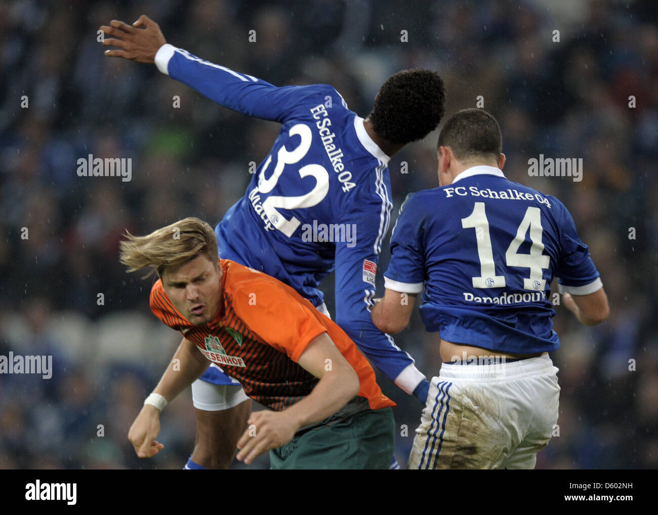 Bremen's Sebastian Proedl (L) vies for the ball with Schalke's Joel Matip (C) and Kyriakos Papadopoulos during the German Bundesliga match between FC Schalke 04 and SV Werder Bremen at Veltins-Arena in Gelsenkirchen, Germany, 10 November 2012. Photo: Daniel Naupold (ATTENTION: EMBARGO CONDITIONS! The DFL permits the further utilisation of up to 15 pictures only (no sequntial pictur Stock Photo