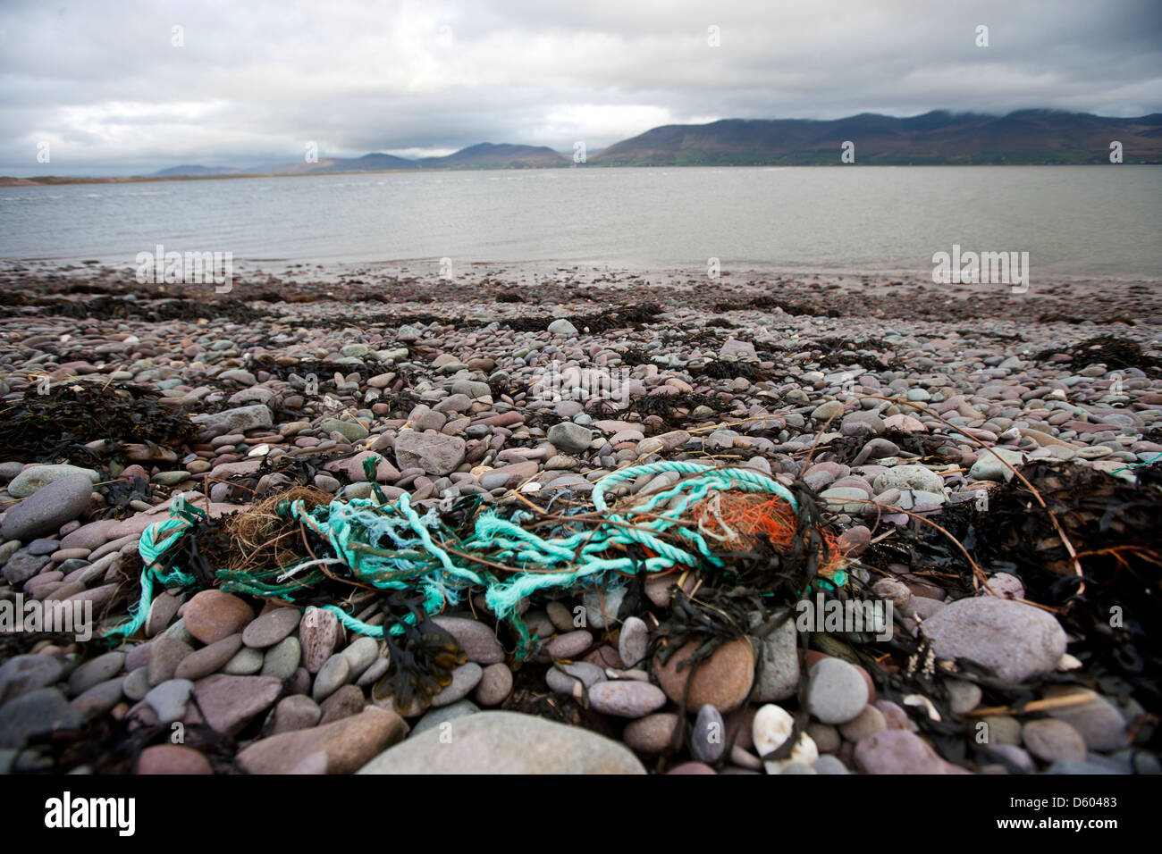 Rubbish shore with water in background Stock Photo