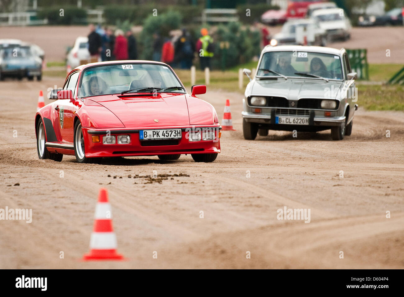 A Porsche 930 Turbo (l) and a Renault R16TL are pictured during the Oldtimer Rallye 'Revival Berlin' at Trabrennbahn Mariendorf in Berlin, Germany, 10 November 2012. More than 50 historical automobiles compete for highest speed, some of them are piloted by former motor sportsmen. Photo: Robert Schlesinger Stock Photo