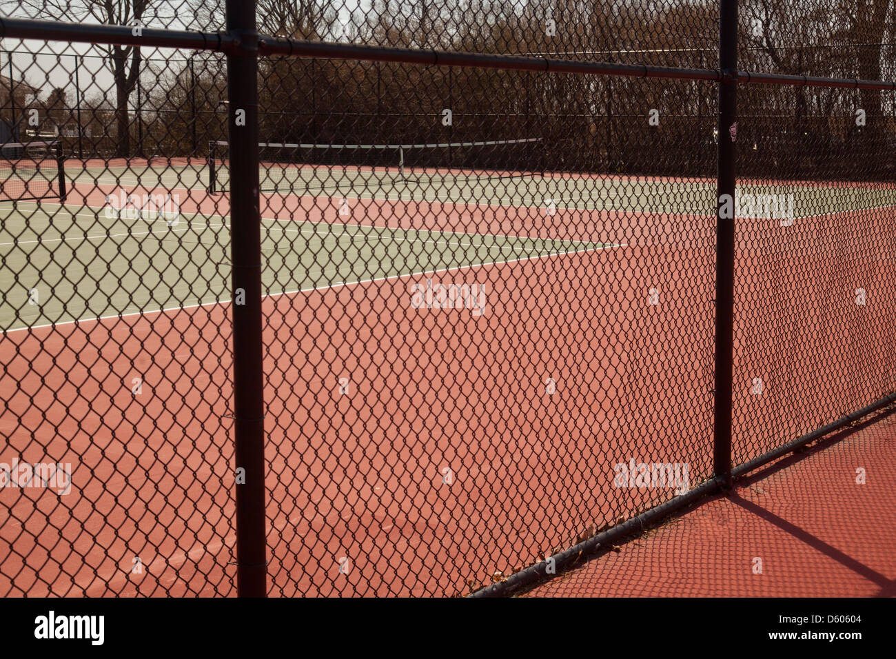 clay tennis courts with fence Stock Photo
